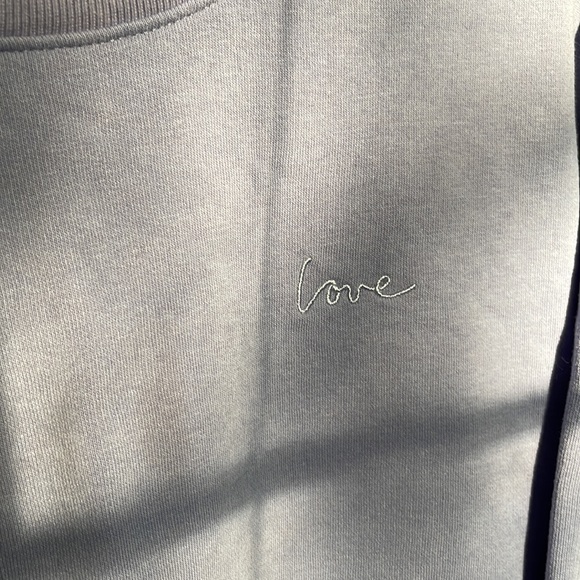 H&M Sweaters - Purple crew neck line with an embroidered love on it